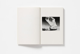 Open book with an image of a military balloon that resembles a whale