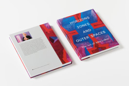 Two copies of the John Loker book are angled on a white surface, showing the front cover with a blue and red abstract painting and title, and the back cover with text and a small abstract painting. 