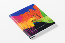 The Lucy Jones: Awkward Beauty book, angled to show its vibrant abstract landscape cover in blues, oranges, pinks, and greens, with the title visible on the cover and spine.